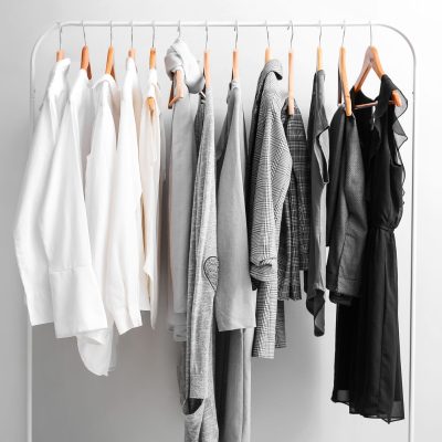 Rack,With,Stylish,Clothes,On,Light,Background